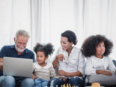 diverse family looking at a laptop