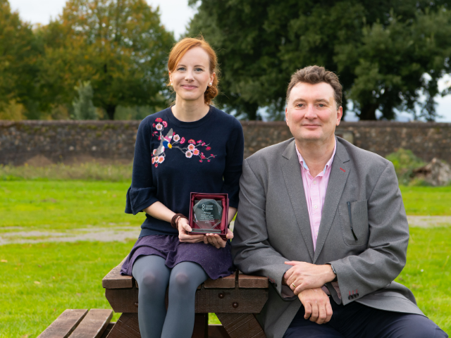 two people posing with award