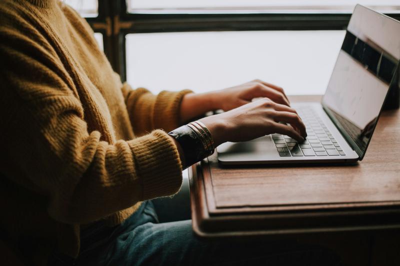 a_person_typing_on_a_laptop