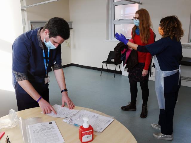 Man and two women in research clinic