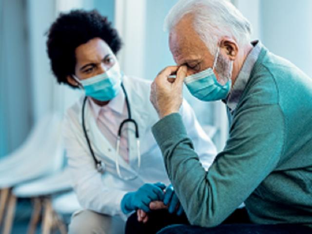 Man in face mask consulted by doctor