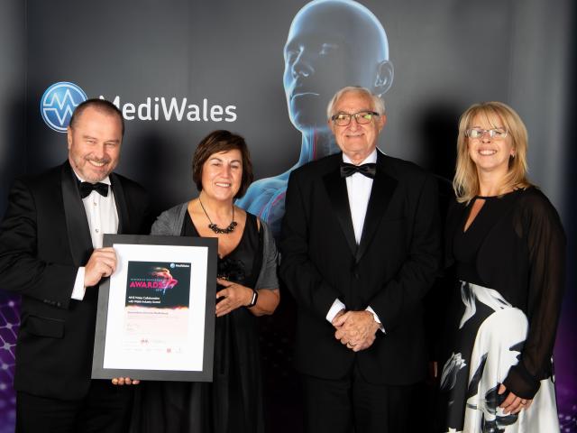 Four people receiving a MediWales Innovation award