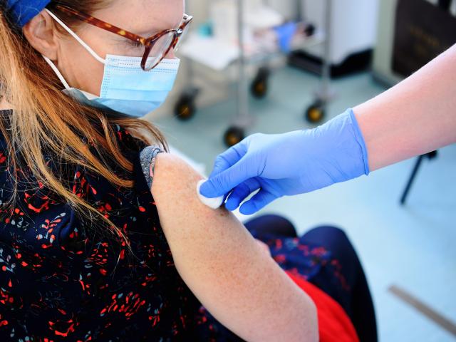 Woman receiving COVID-19 booster vaccination