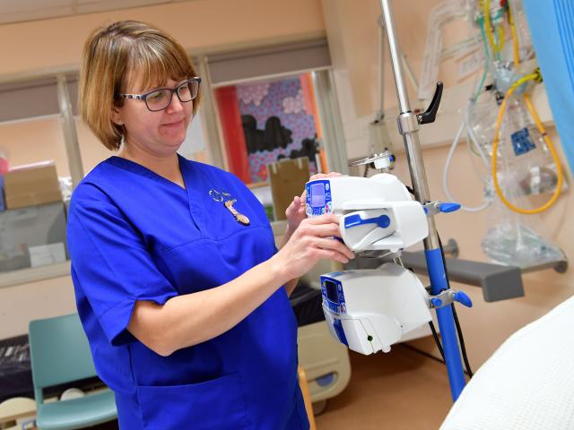 Research nurse using machinery