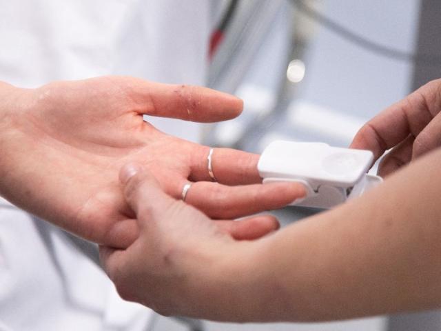 Close up of someones hand having their pulse checked