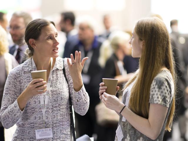 Two female delegates chatting