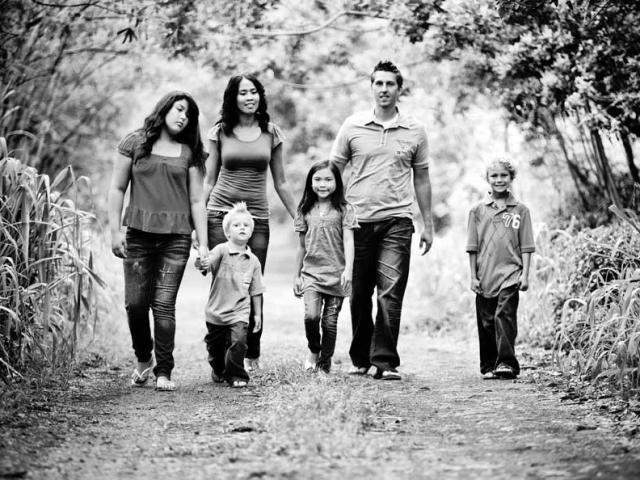 A family waling in the forest. 