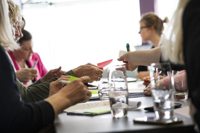 Female attendees discussing research in a workshop