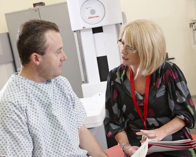 a female clinician speaking to a male patient