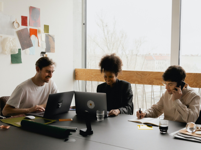 A group of people sitting around a table a discussing research. 