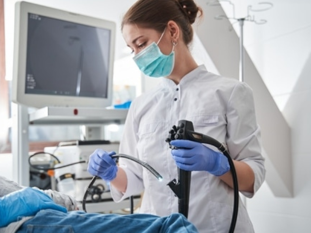 A female doctor performing a gastroscopy.