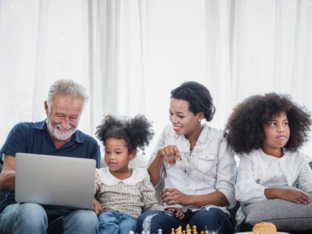 family working on a laptop together