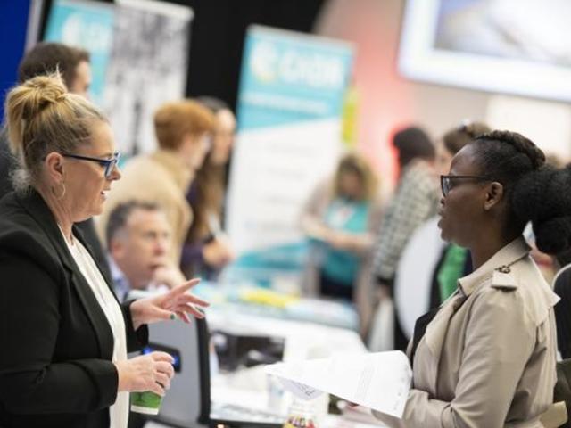 Two women discussing health and care research