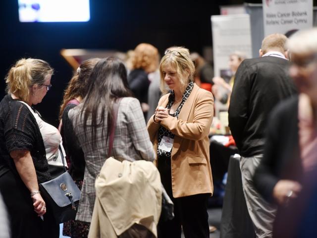 people chatting at a conference exhibit