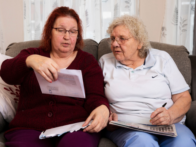 Two women sat on a sofa