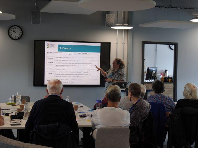 people sitting looking at presentation 