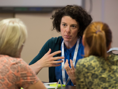 Three females discussing research.