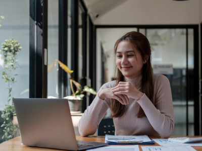 Woman looking at laptop screen and smiling