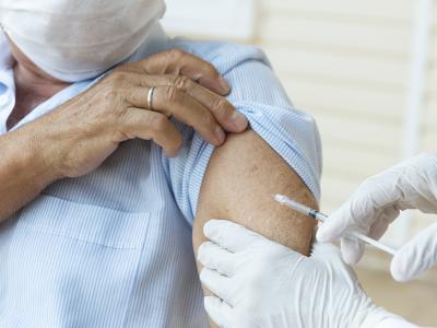 Elderly man getting a flu jab. 