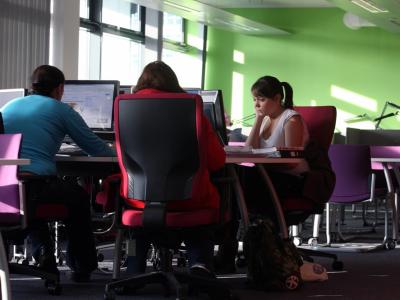 Three women working at pcs