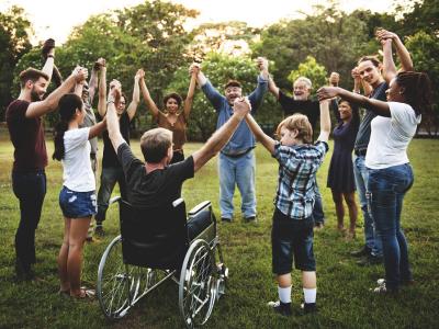 Diverse group of people holding hands in a circle