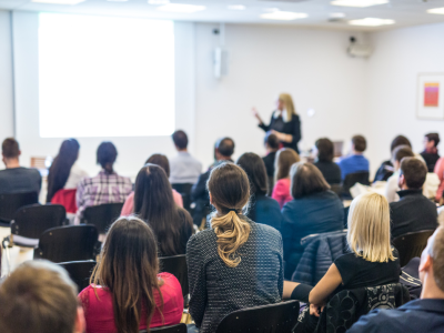 woman presenting at conference