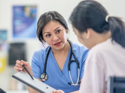 a_female_clinician_talks_to_a_woman