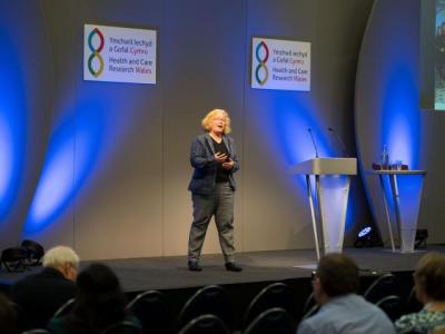 a_woman_presenting_on_stage