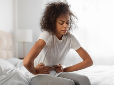 a_woman_bending_over_in_pain