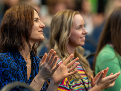 two_women_in_an_audience_clapping