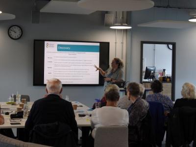 people sitting looking at presentation 